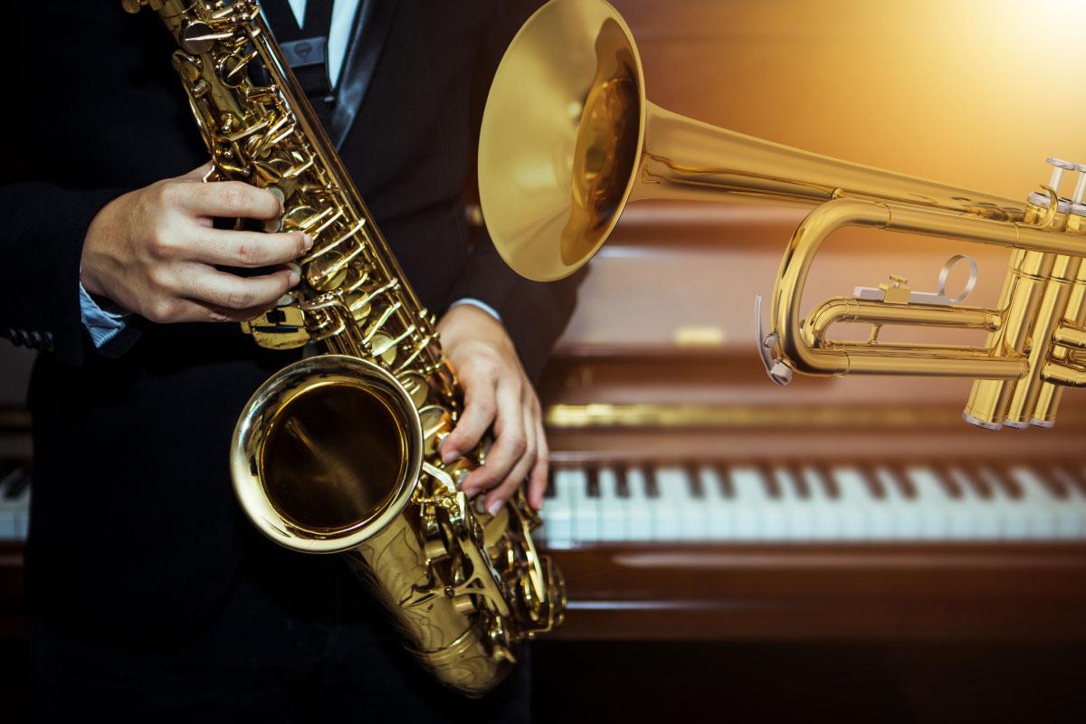 A trumpet, a piano and a gentleman in a suit playing a saxophone